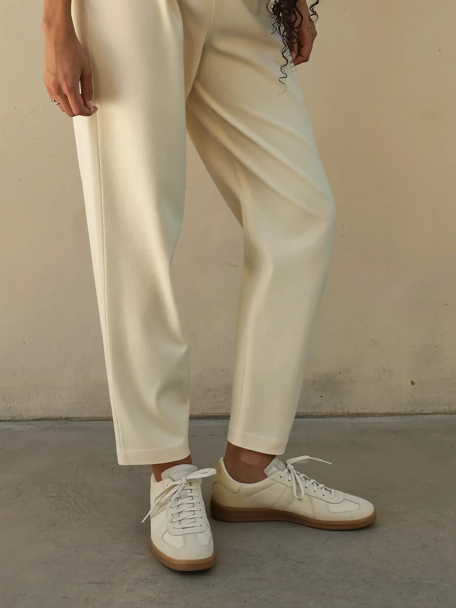 Model wearing the Cream Court Low Sneaker.