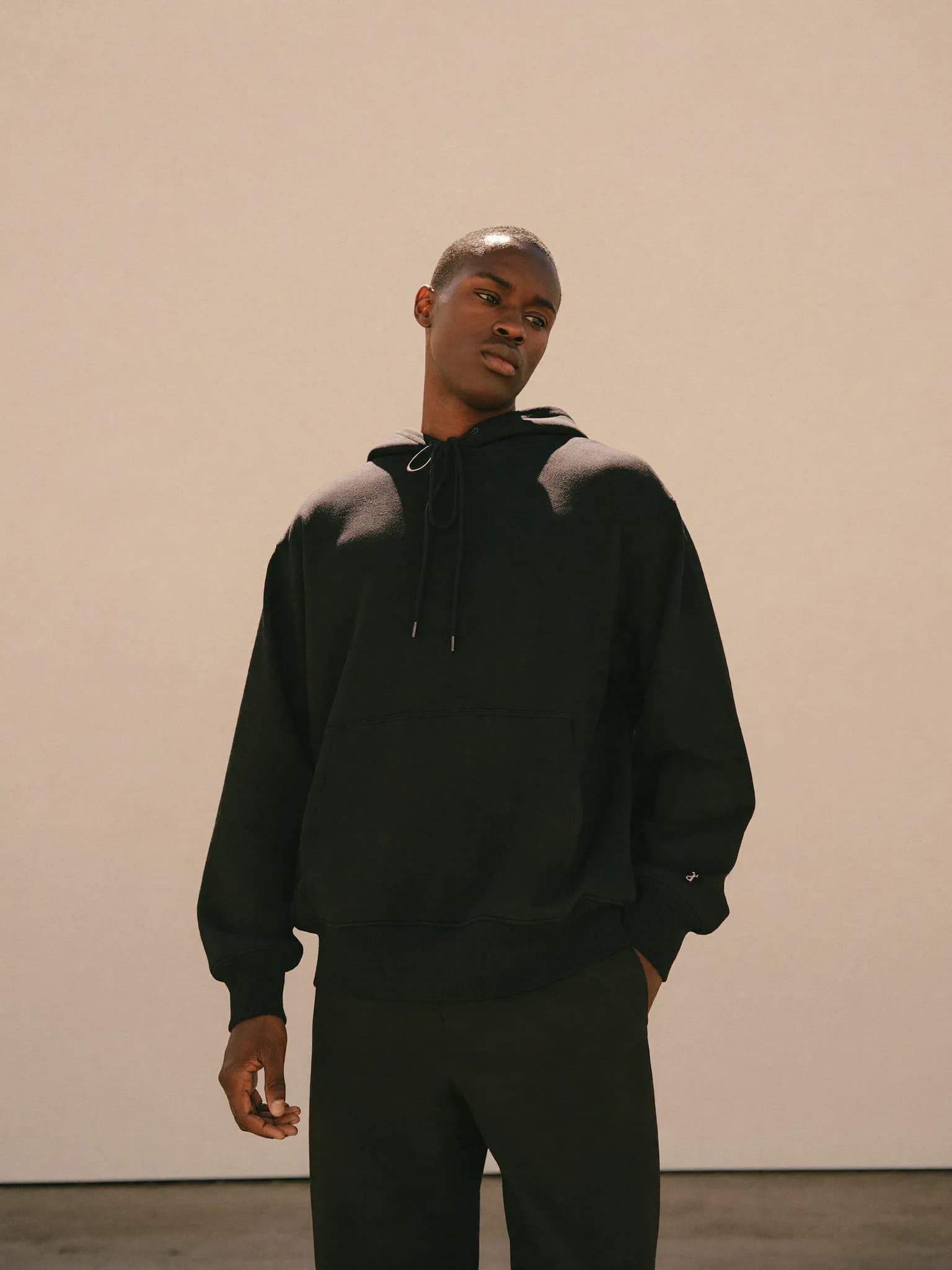 Model wearing the Black Heavyweight Pullover Hoodie.