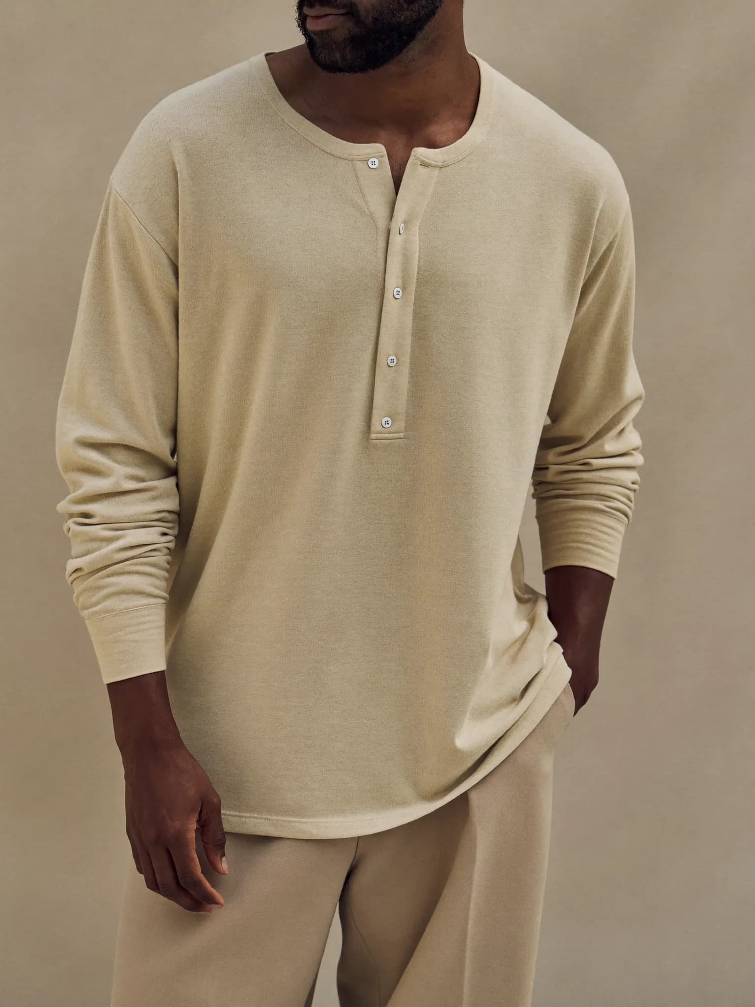 Model wearing the Oat Long-Sleeve Henley.