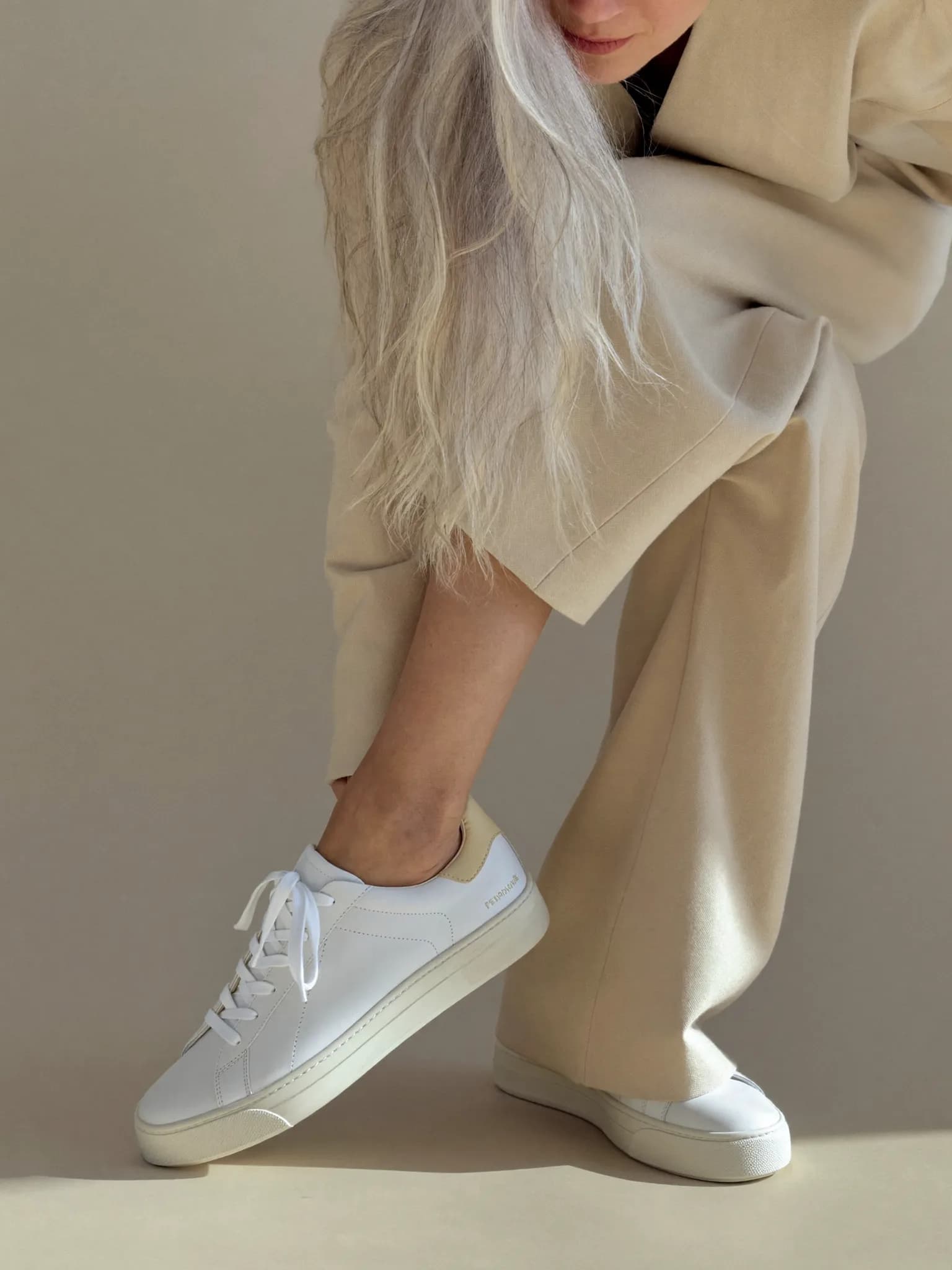 Model wearing the White Minimalist Leather Sneaker.